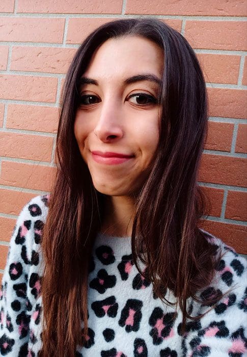 A woman with long hair and a leopard print sweater.